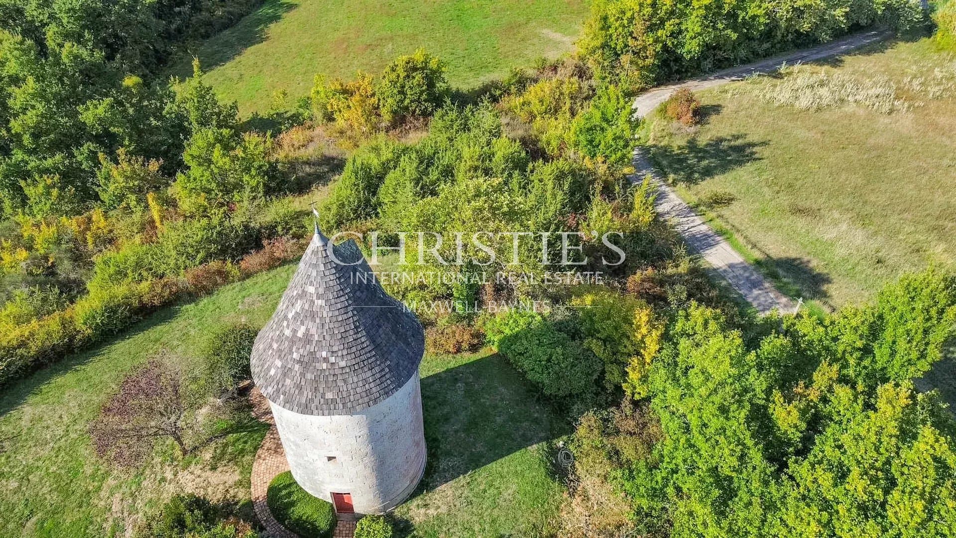 A breathtaking walled Domain featuring a windmill, nestled amidst 17+ hectares of scenic hilltop land